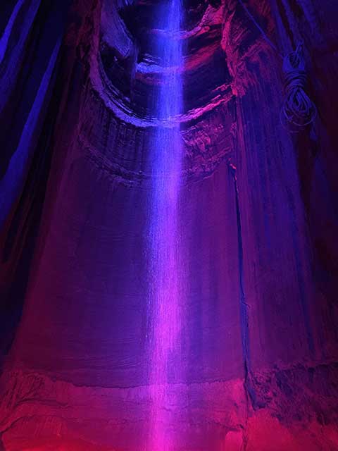 ruby falls illuminated in purple light